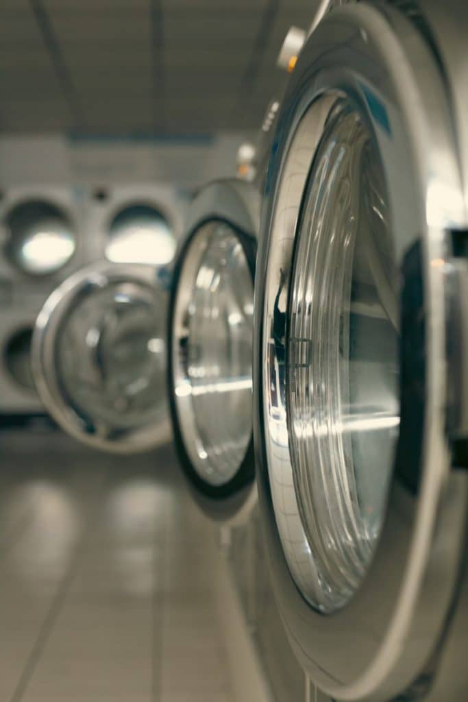 a row of silver and black washing machines